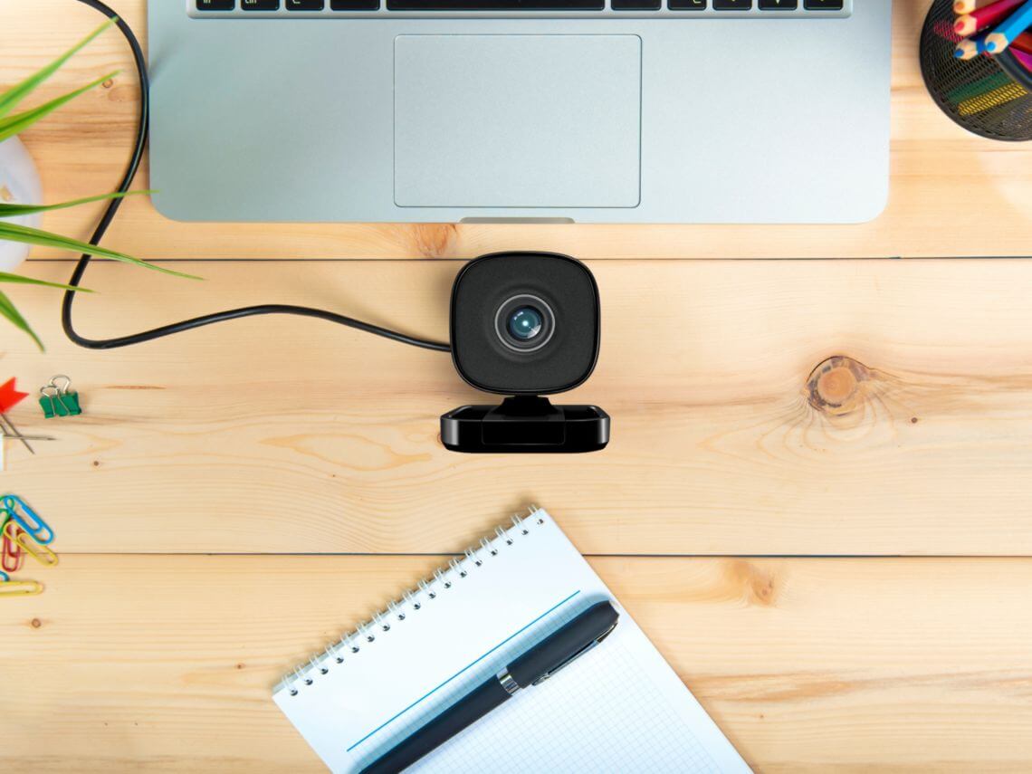 A desk with a laptop and webcam cloud