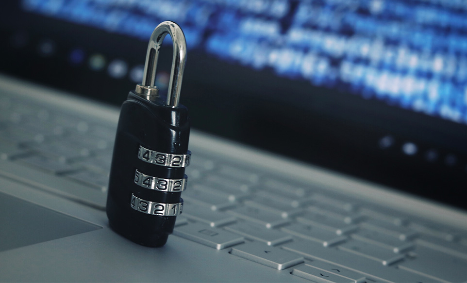 A lock sitting on top of a laptop keyboard indicating ransomware protection