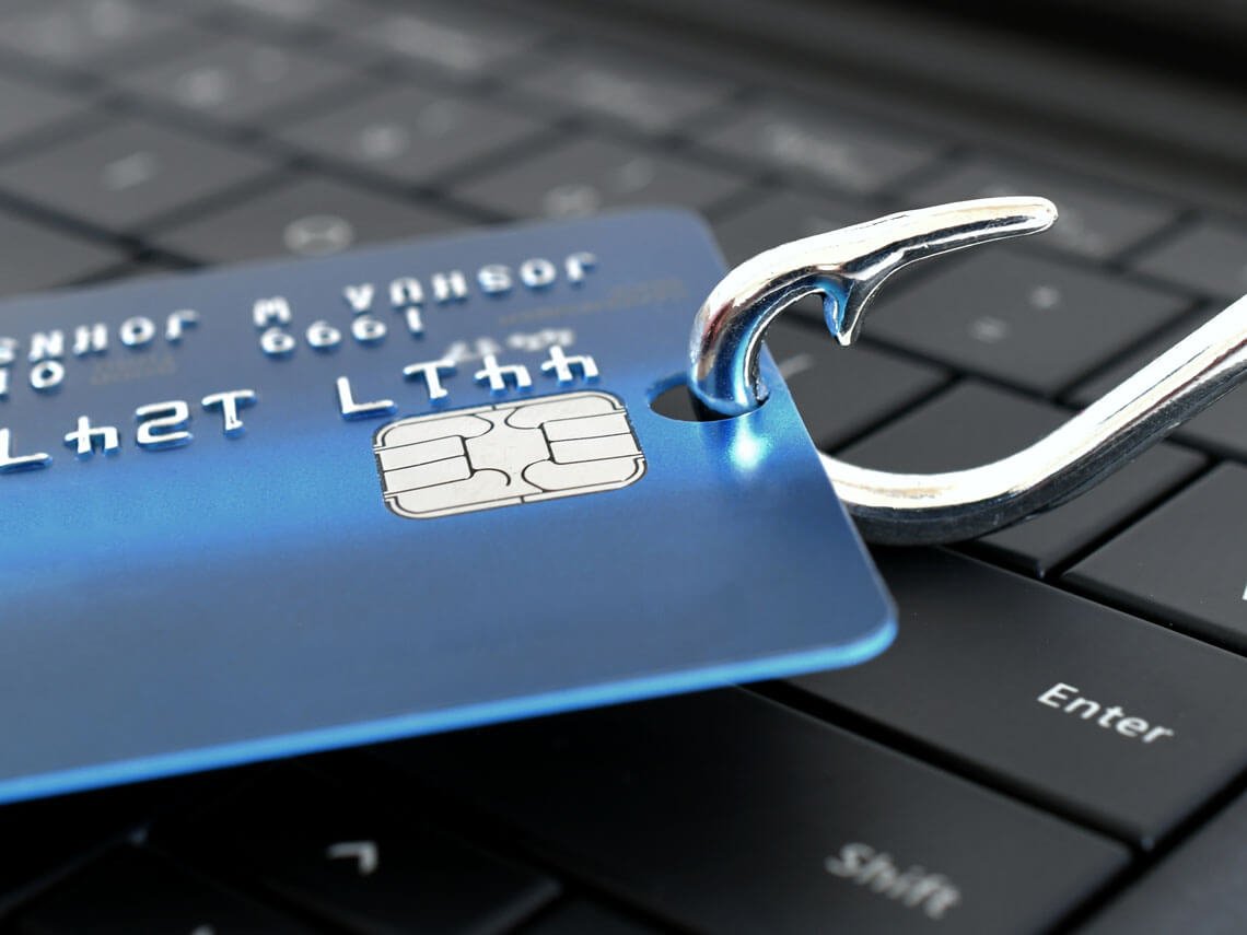 credit card and hook symbolizes social engineering attack of phishing